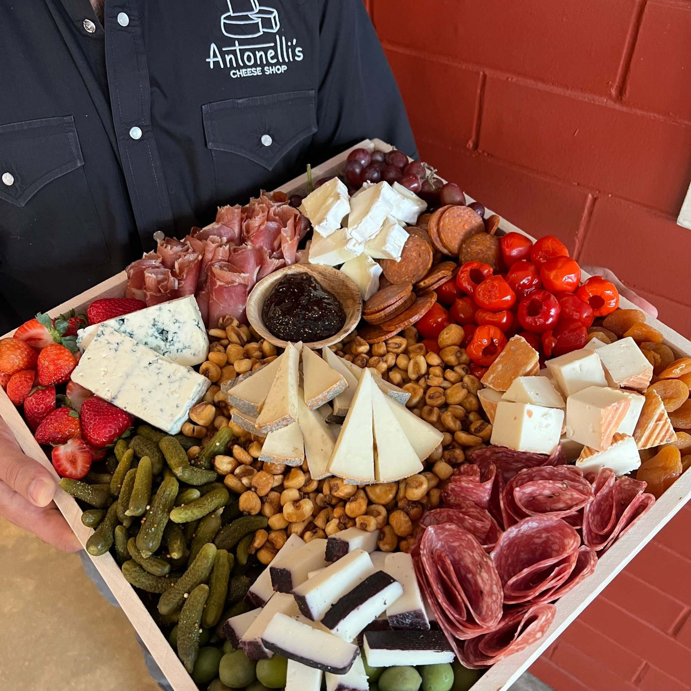 Person holding a large Cheese and Charcuterie Board - Christmas Charcuterie Board