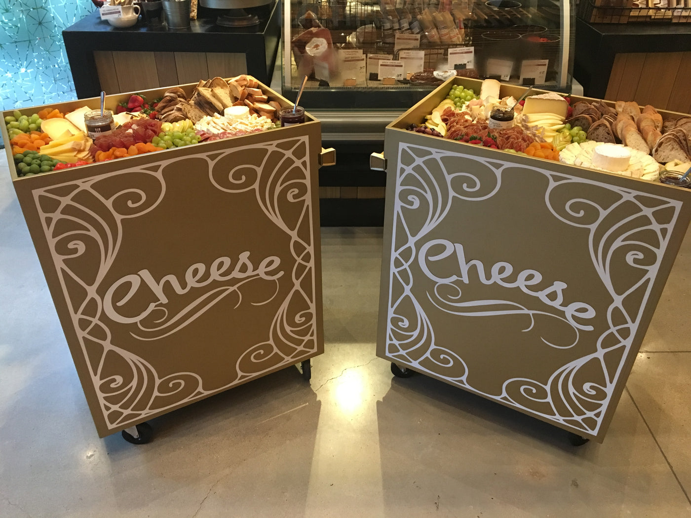 two cheese carts full of cheese grapes and olives for your next creative charcuterie board