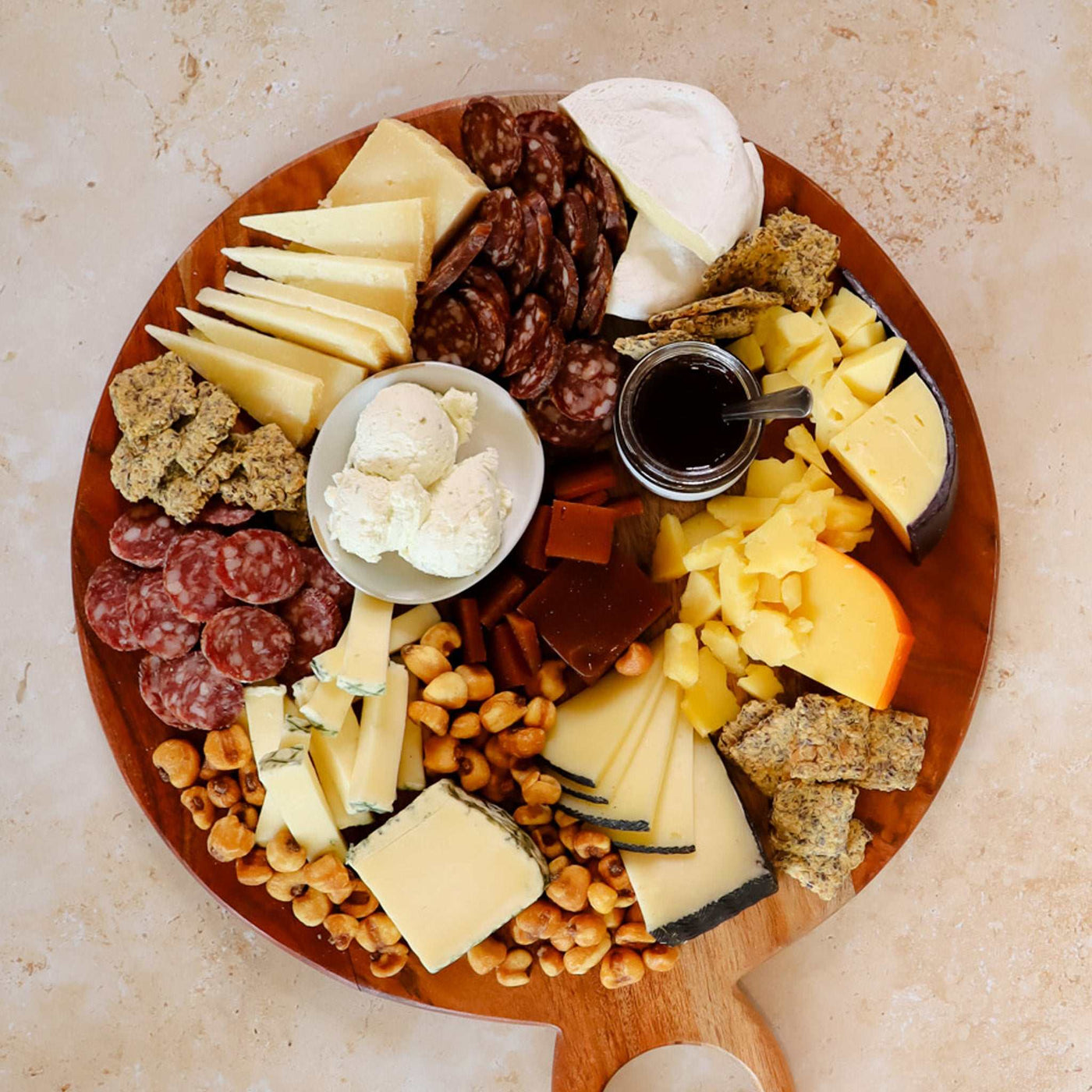 Image of 7 Cheeses and Pairings Curated on a cheese board 