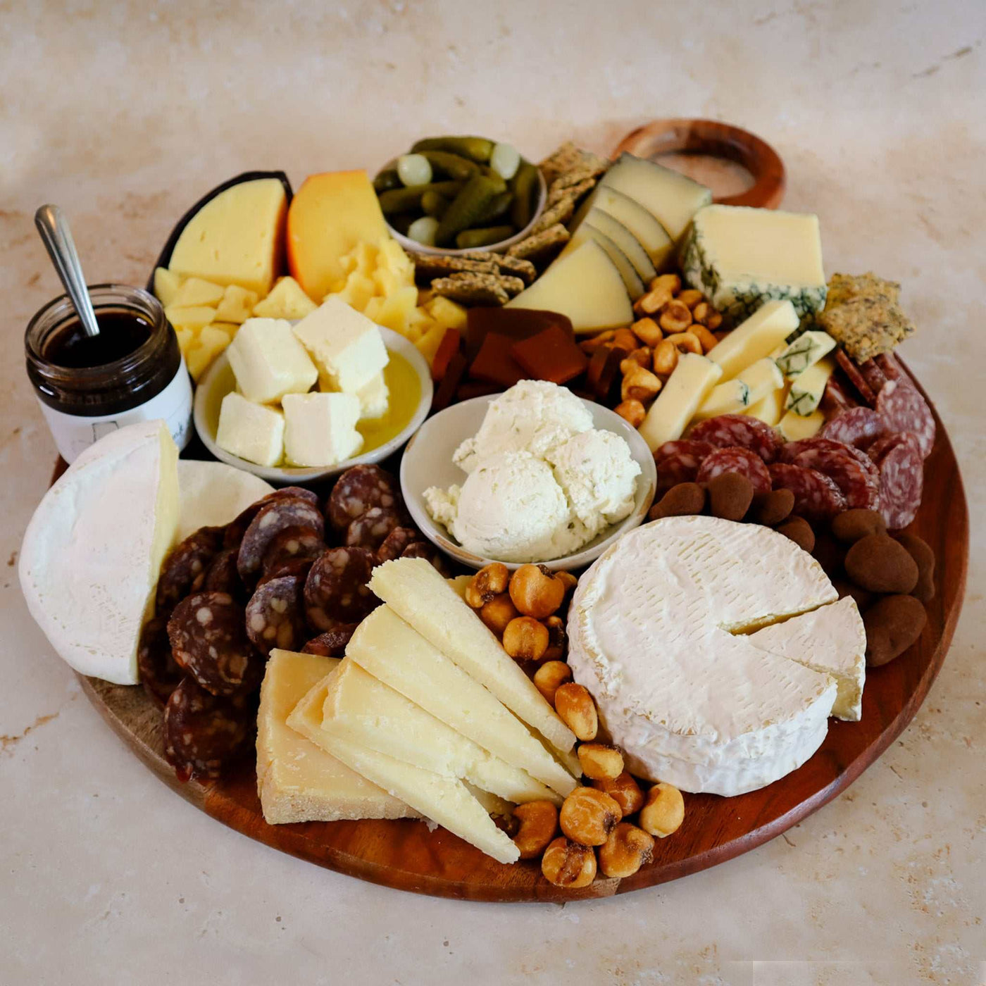 Image of 9 cheeses on a cheese board with pairings