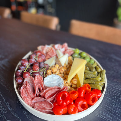 image of a charcuterie board for two on a black dinner table