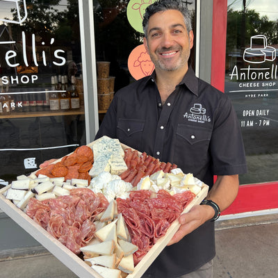 Owner John Antonelli holding a Cheese & Meat Tray Large