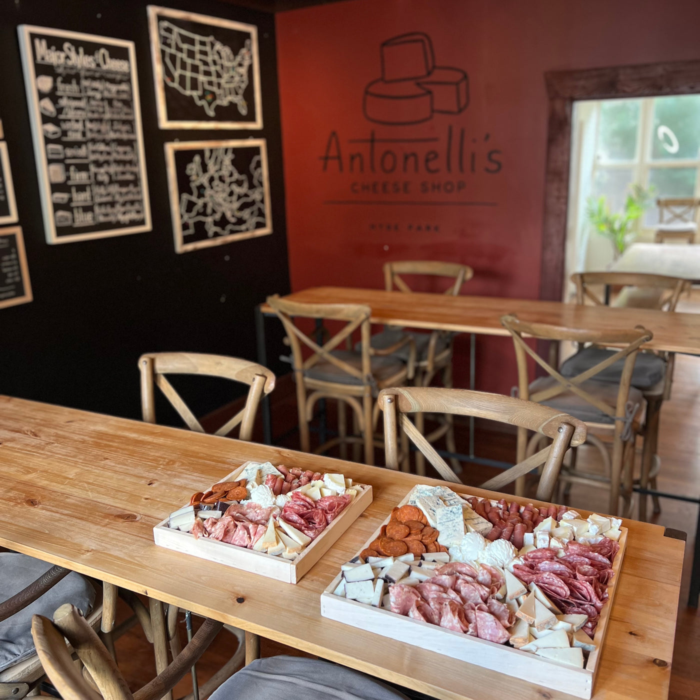 Cheese & Meat Tray Large next to the small on a table in Antonelli's Cheese House