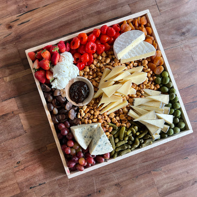 vegetarian cheese board on a picnic table from top view angled