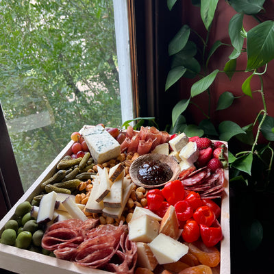 Thanksgiving Charcuterie Board in natural light with greenery