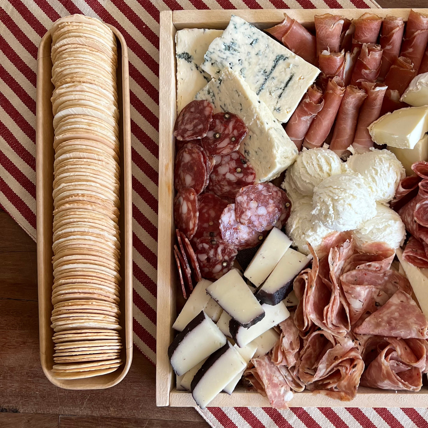 partial image of charcuterie board next to a sleeve of crackers