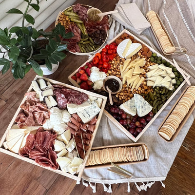 SIde view of a displayed grazing table on a white table cloth.