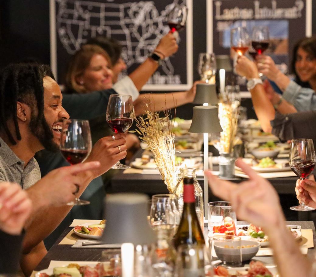 image of customers raising glasses for a toast