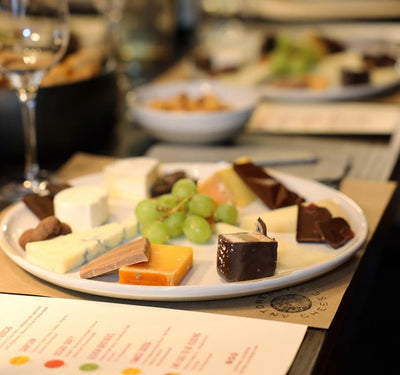 image of antonelli's cheese plate with chocolate, cheese and grapes