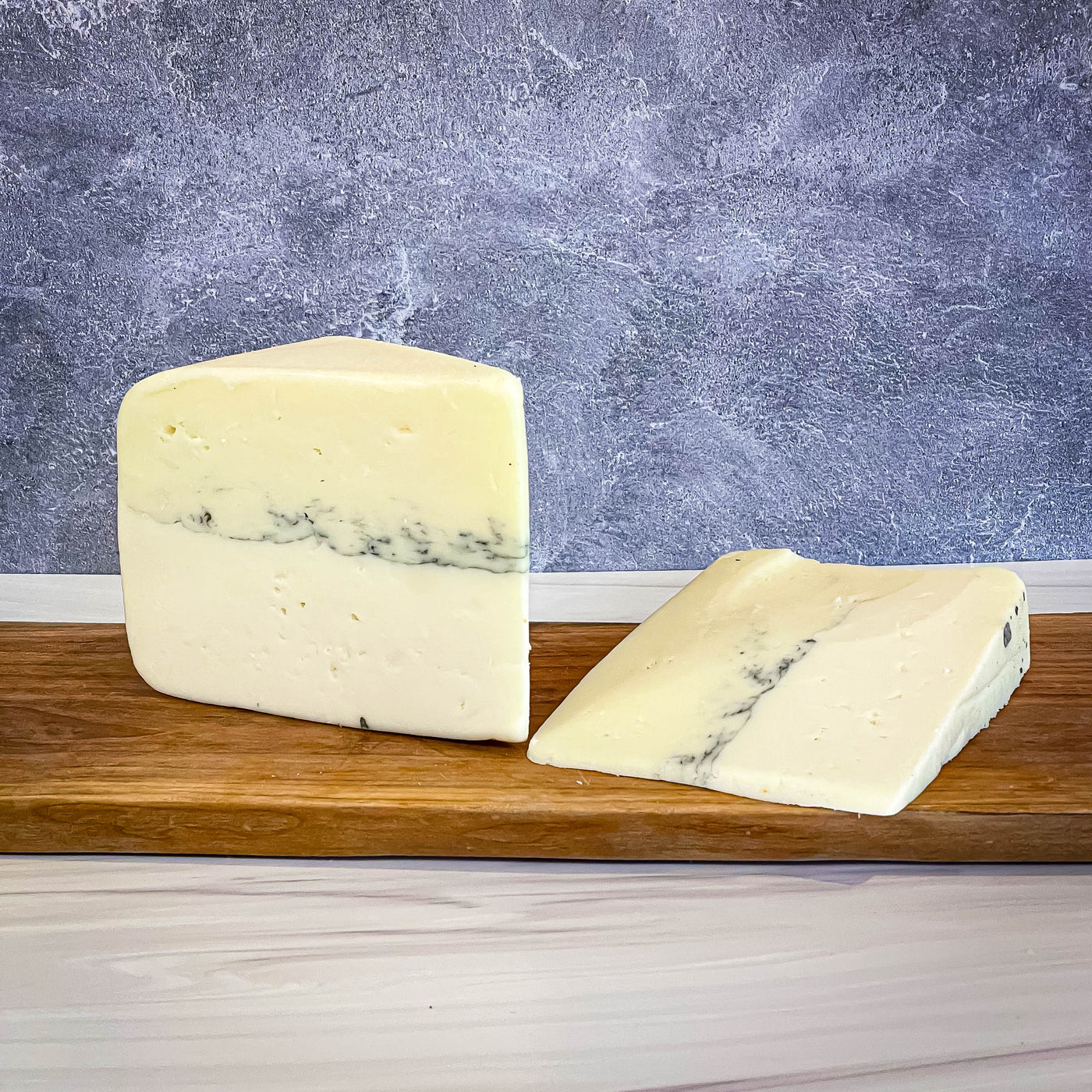 MOBAY cheese by Carr Valley Cheese, semi-soft, layered with goat and sheep milk, featuring vegetable ash, Wisconsin.